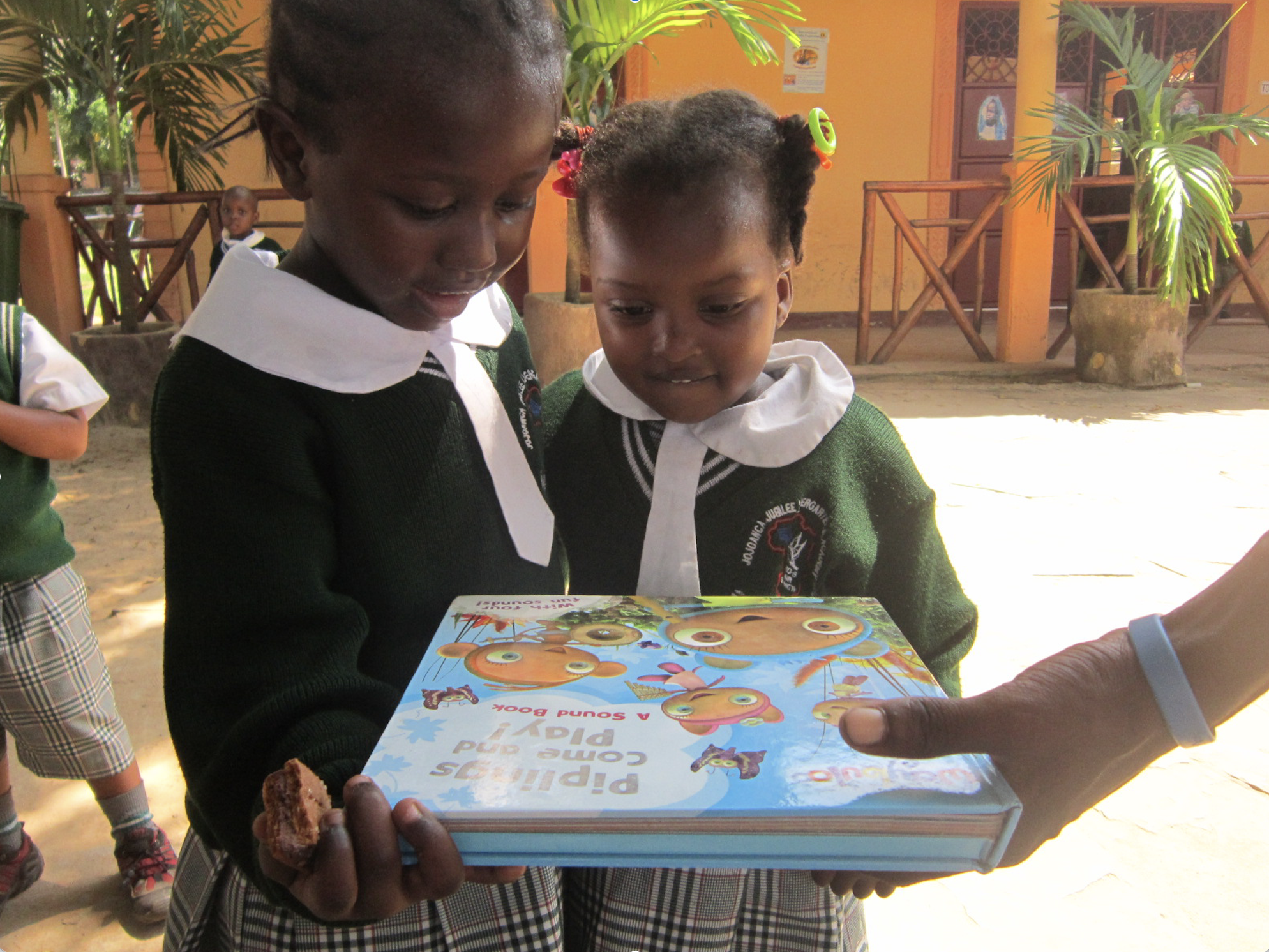 Girls admiring book Library Starter